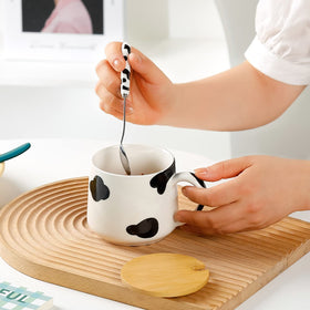 BigNoseDeer lead-free ceramic mug features hand-painted cow print.