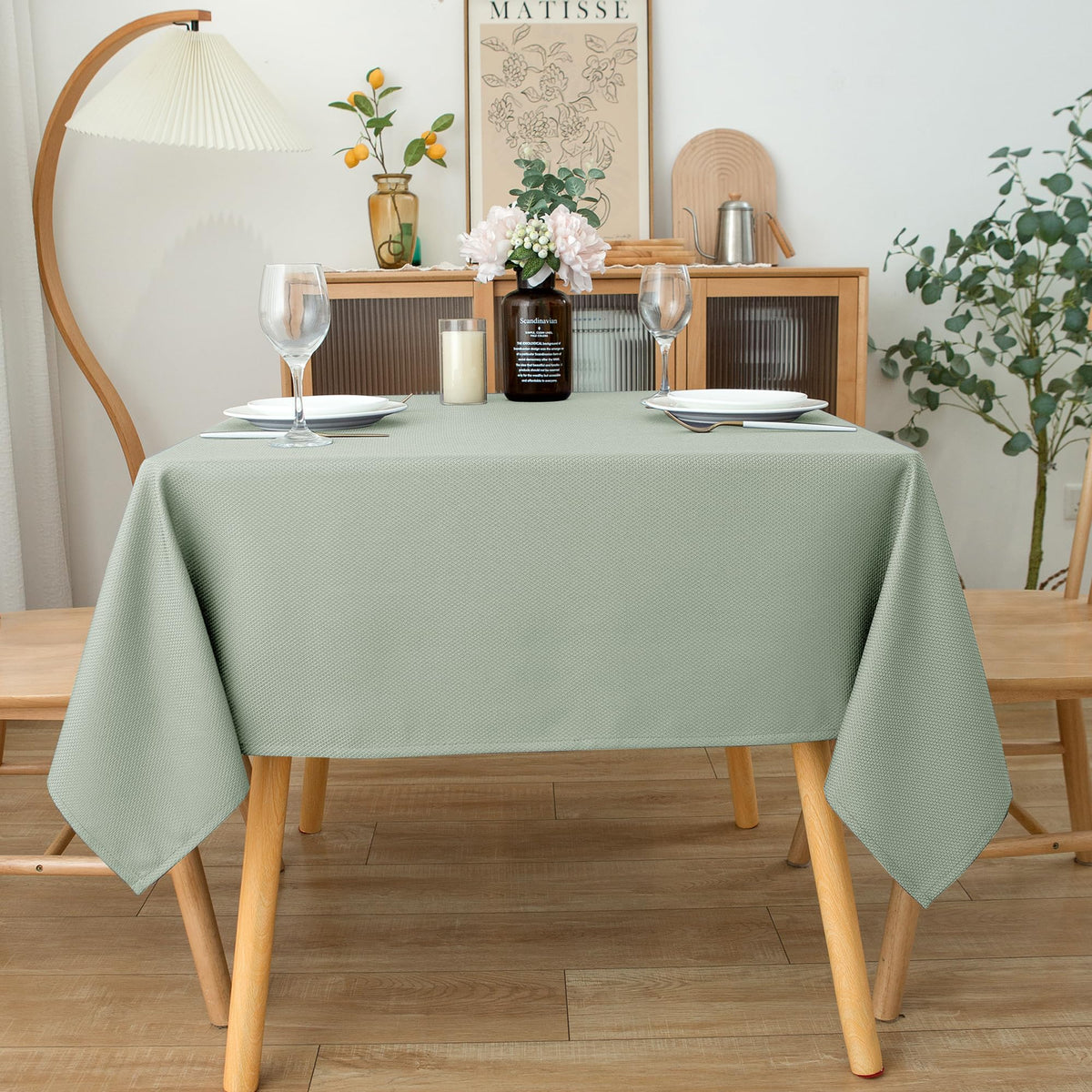Biscaynebay Sage tablecloth shows water-bead resistance for spills and quick cleanup.