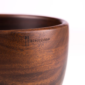 Biscuitique walnut bowl close-up shows rich wood grain and premium craftsmanship.