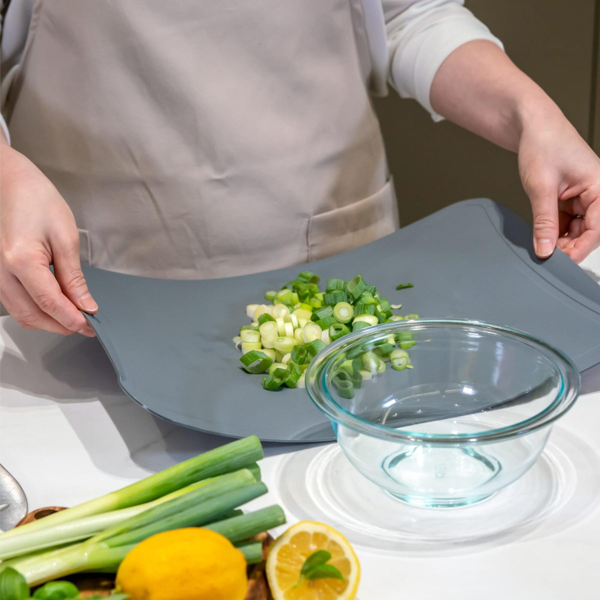 Blue Ginkgo cutting mats with textured surface catch liquids, reducing countertop mess.