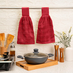 Blue Needles red towel close-up emphasizes absorbent fabric for spills.