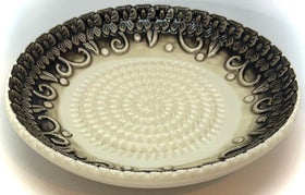BonCera plate surface closeup highlights embossed black design.