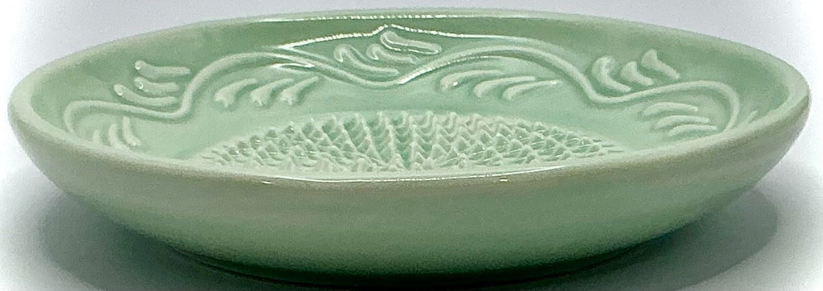 Turquoise green floral edge BonCera plate adds vibrant kitchen style.
