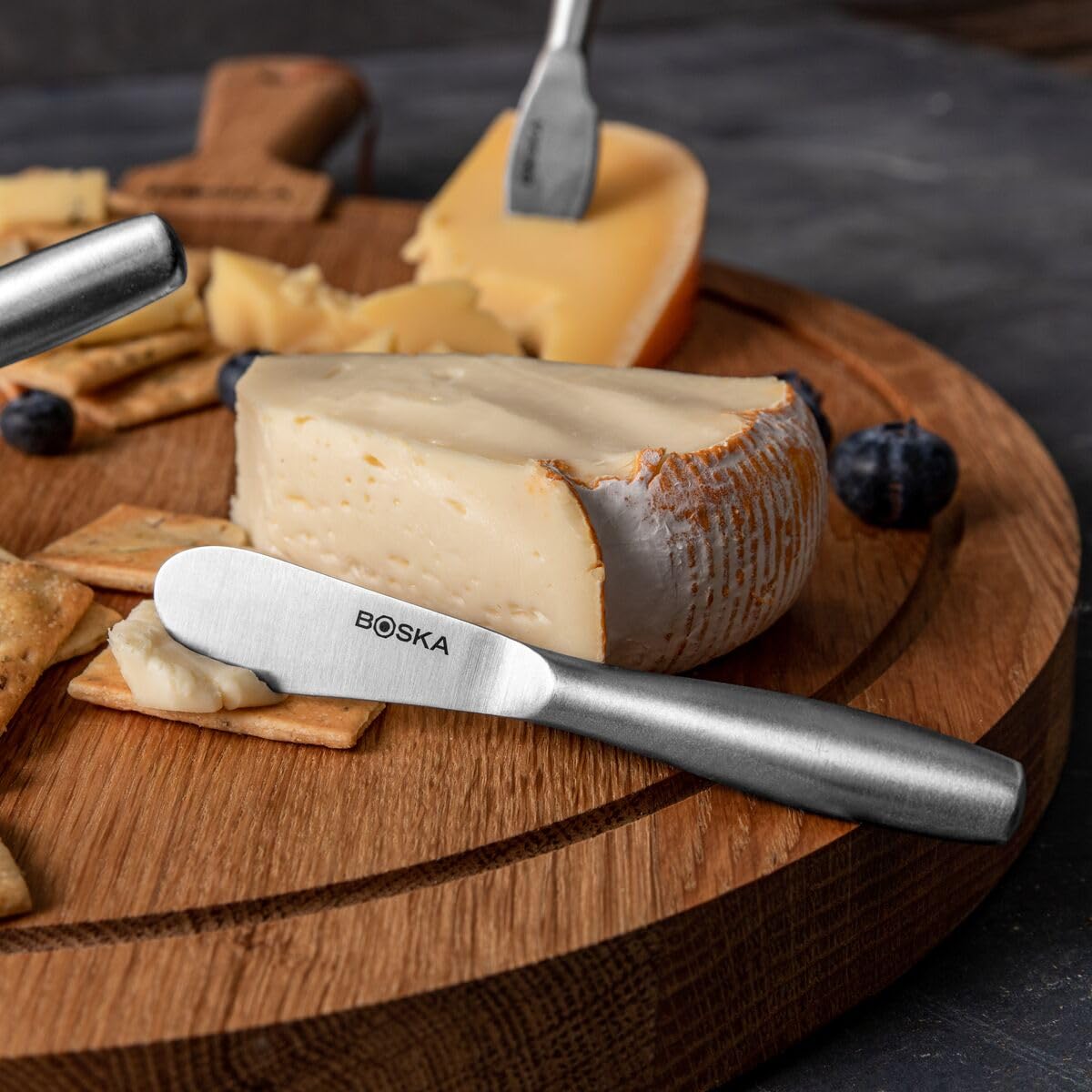 Boska cheese knife set displayed on a cheese board for presentation.