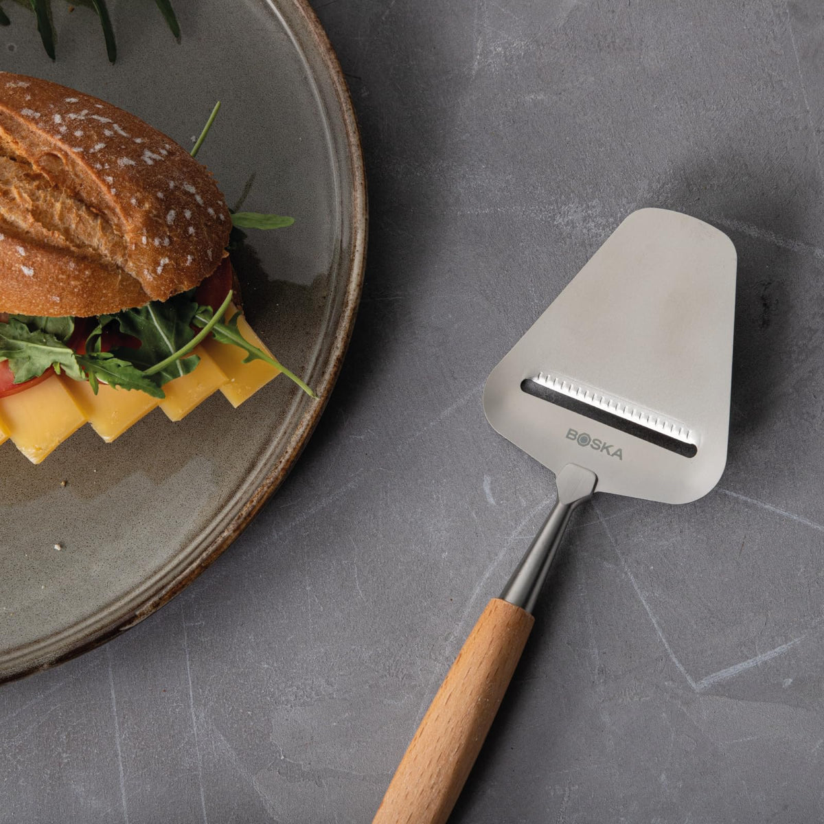 Boska Amigo blade in action delivering clean cheese slices with stainless steel durability