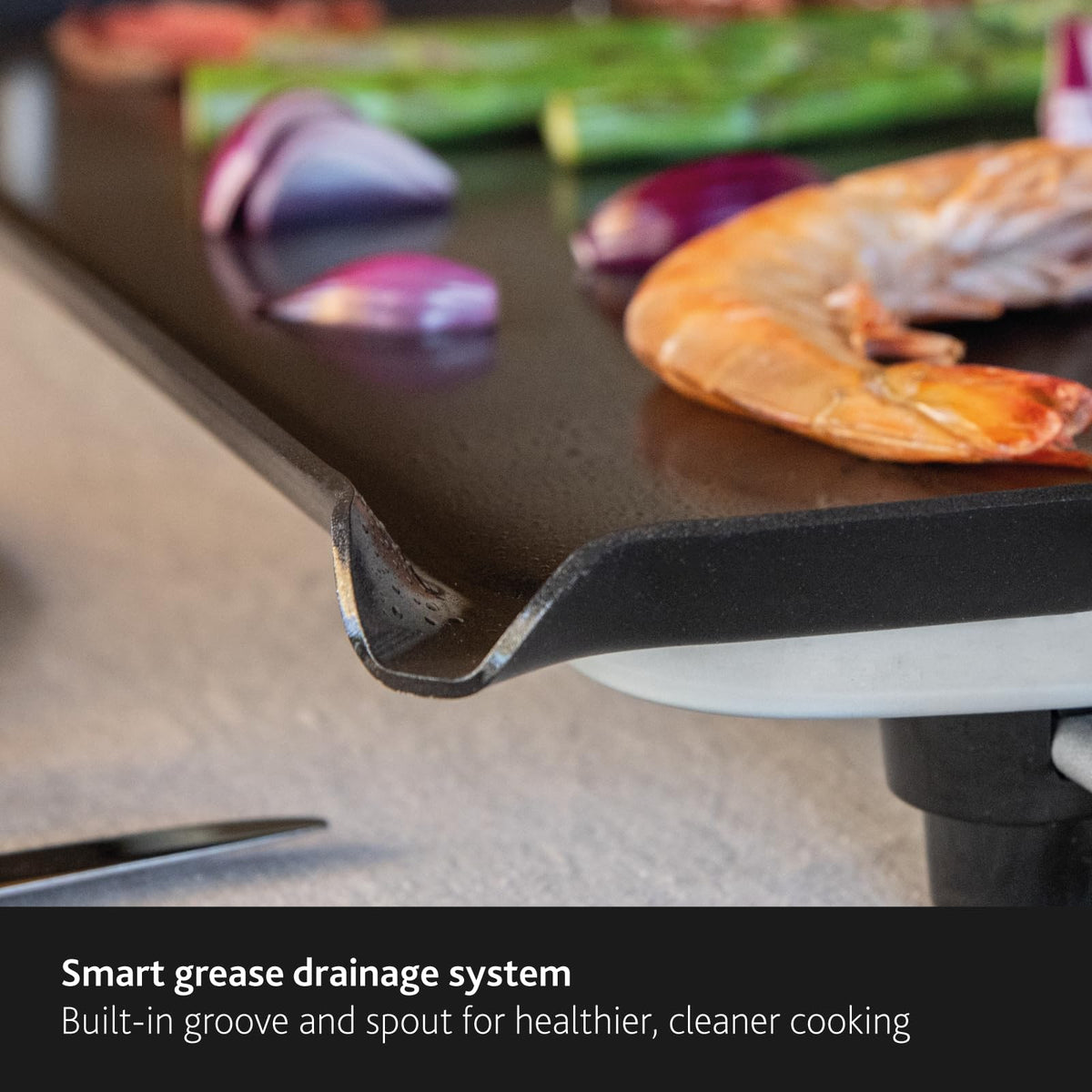 BOSKA Large Electric Griddle Pro searing meat on the griddle for even browning.