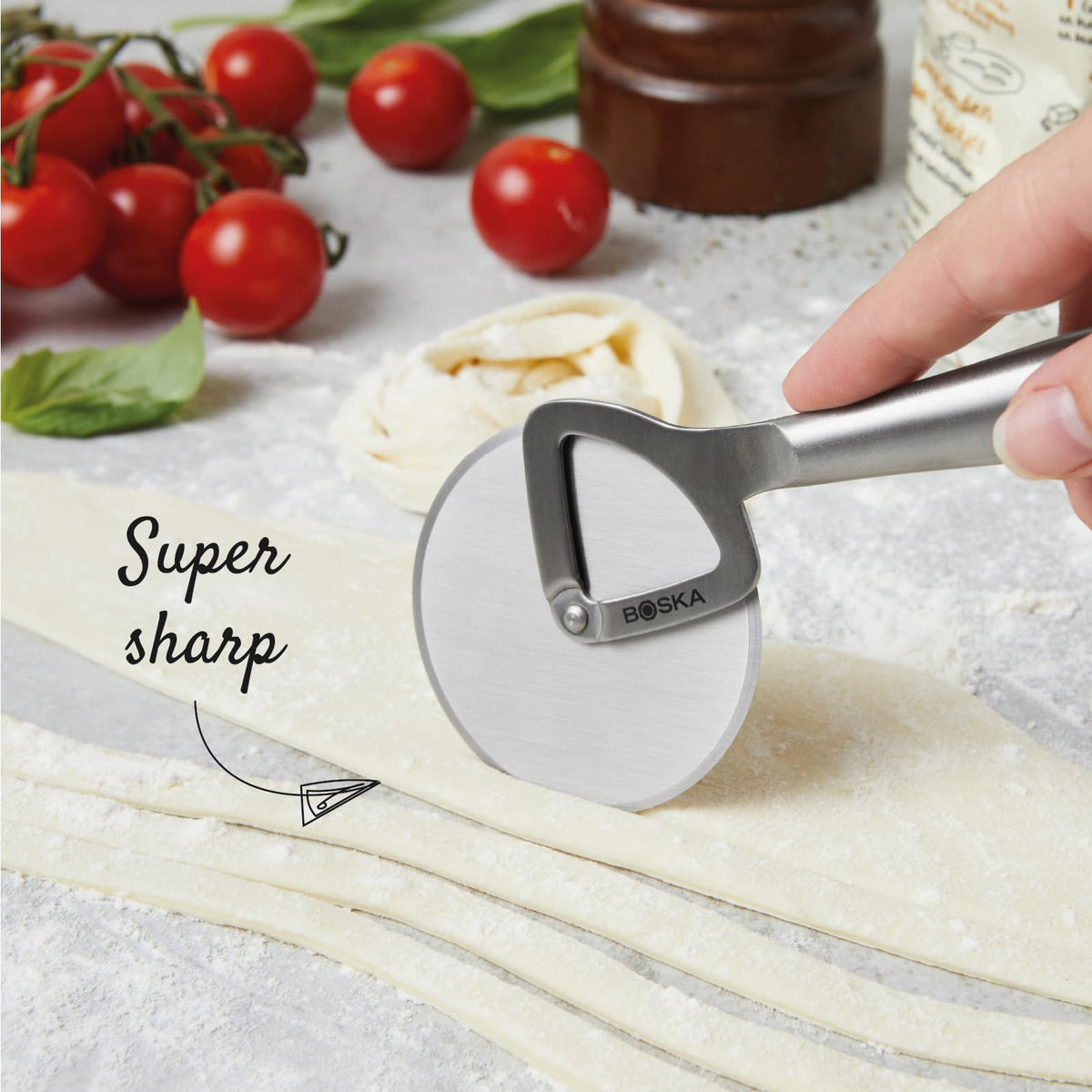 Boska pizza cutter wheel close-up showing a sharp 2.5-inch blade for clean cuts.