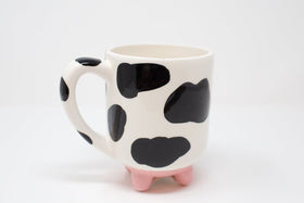 Boston Warehouse Udderly Cow Mug features non-slip silicone feet for stability.