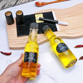 Brajttt bottle with black caps, travel-friendly for sauces and dressings.
