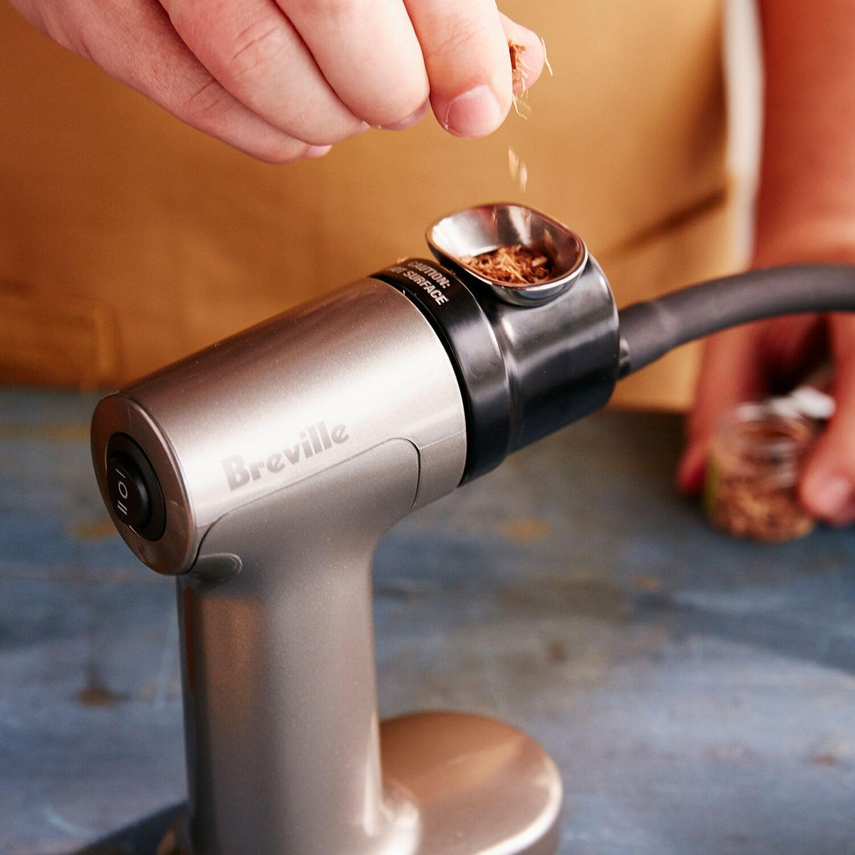Breville BSM600SIL handheld smoker with wood chip samples for flavor variety