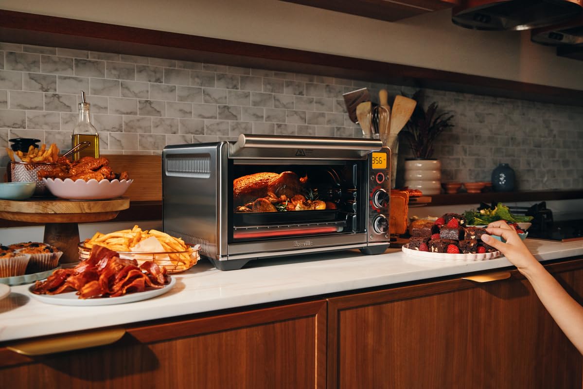 Breville Smart Oven Air Fryer Compact control dial in use for effortless presets.
