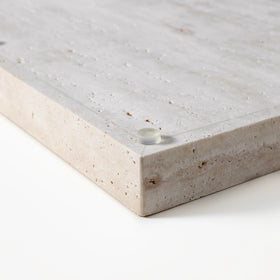 BUICCE travertine tray on dining table used for serving and decor.
