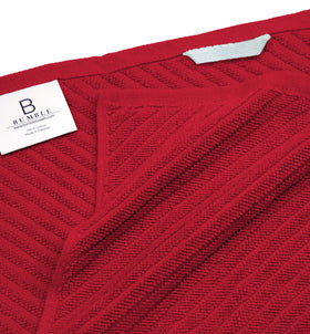 Red towel hangs on a loop for fast air drying