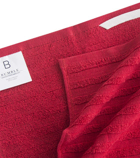 Bumble Towels hanging loop demonstrated for easy drying and organization.