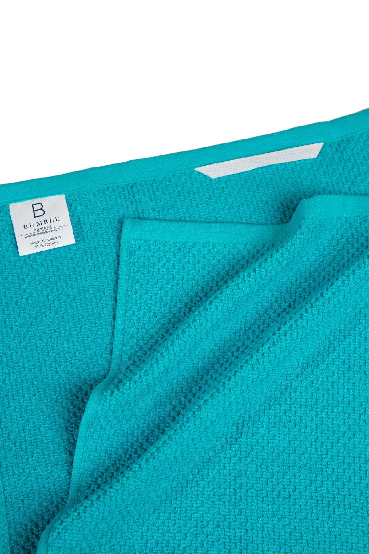 Bumble Towels hanging loop design for quick drying and easy storage.