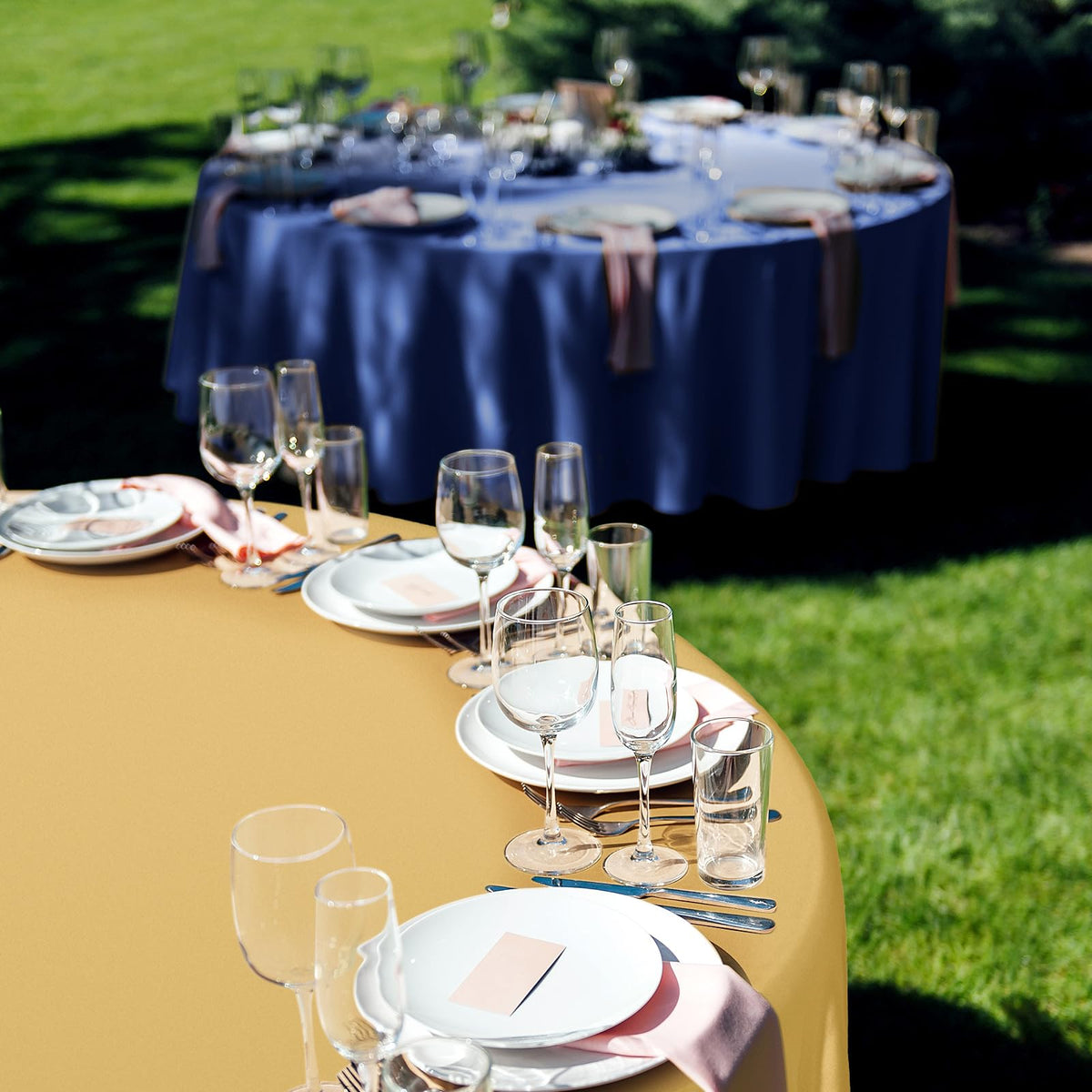 Buryeah wedding or graduation setup shines with navy blue and gold round tablecloths