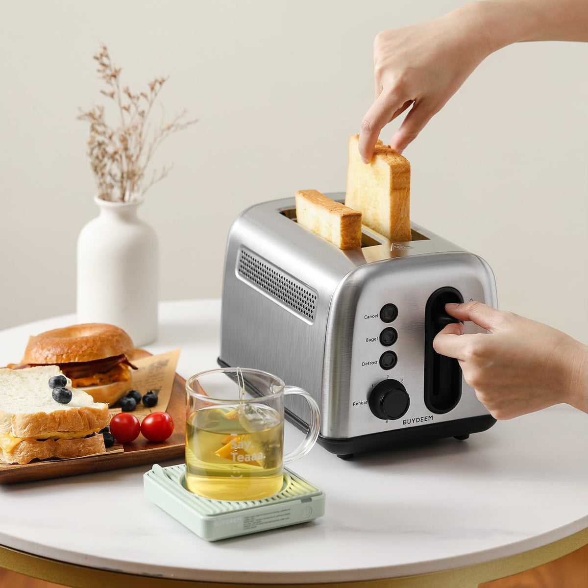 Buydeem DT420 in use to toast bagels and muffins quickly.