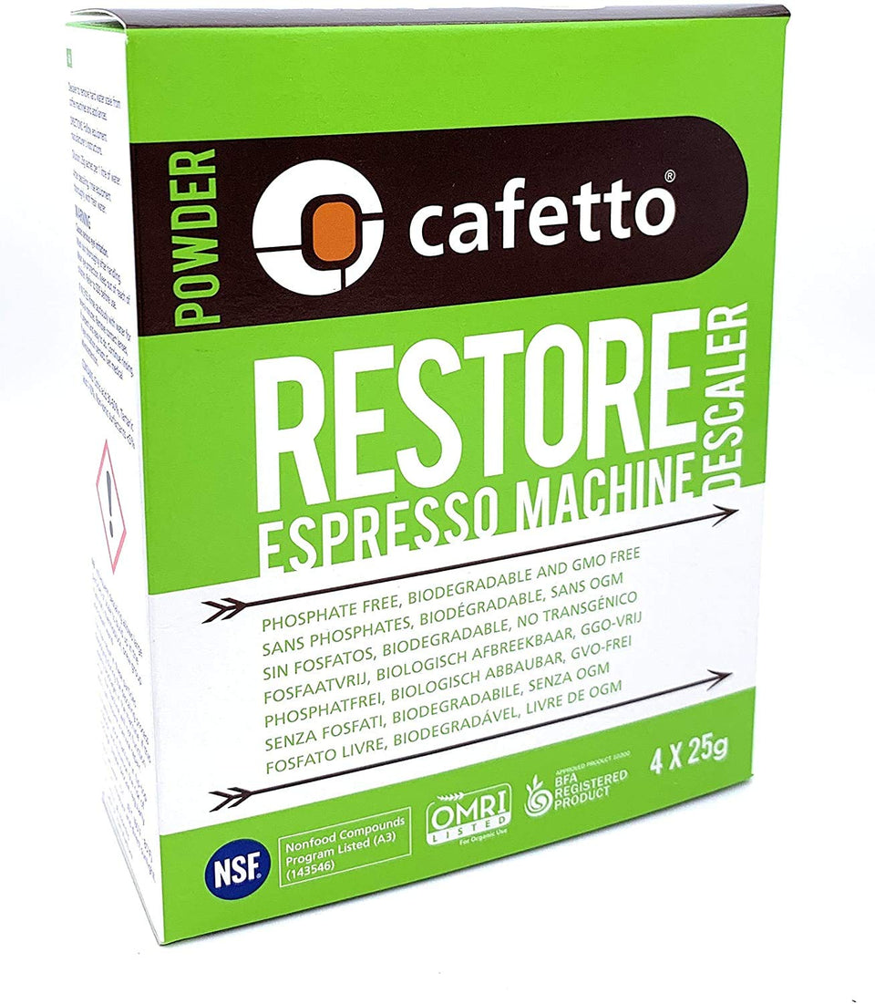 Cafetto Restore descaler 4-pack packets beside a clean espresso machine.