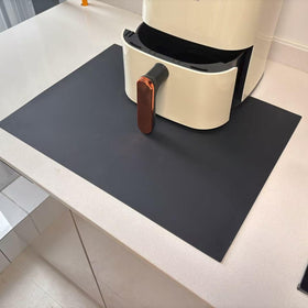 Cafunner silicone heat resistant mat on countertop protecting surfaces from hot appliances.