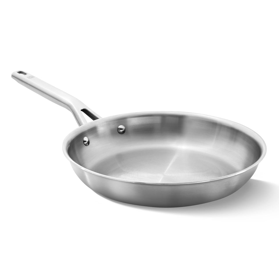 Calphalon 10-inch brushed 3-ply stainless fry pan on stove highlighting even heating.