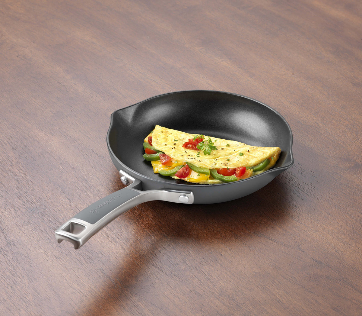 Calphalon Easy System nonstick omelette pan showing pour spouts and ergonomic silicone handle for safe cooking.