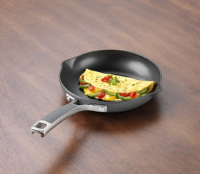 Calphalon Easy System nonstick omelette pan showing pour spouts and ergonomic silicone handle for safe cooking.