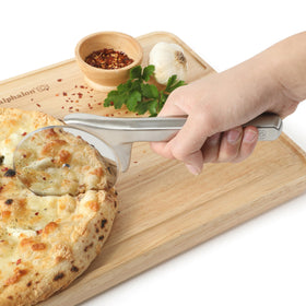 Calphalon Prime pizza cutter in action cutting through crust and toppings.