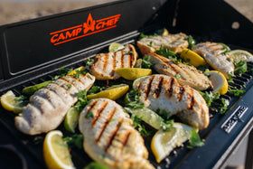 Camp Chef cast iron griddle 16x24, flat side ideal for pancakes and sautéed vegetables.