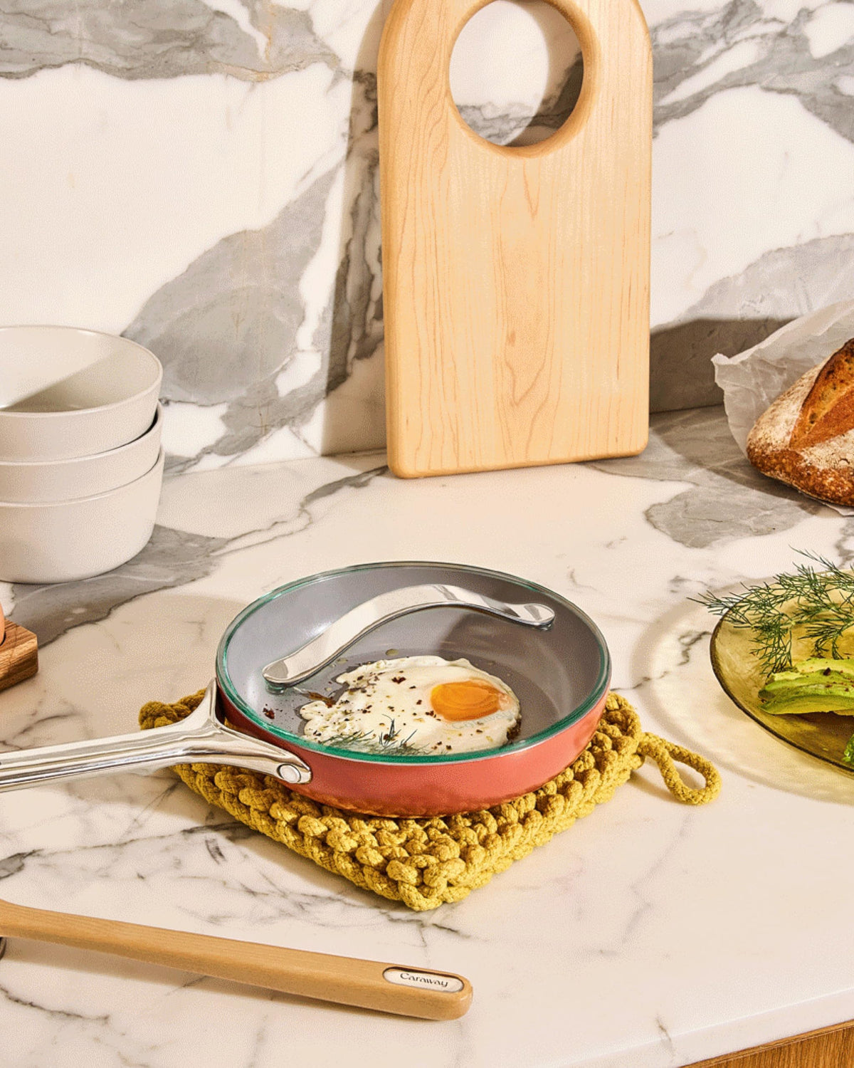 Caraway clear-view glass lid keeps steam visible for safe cooking.