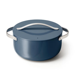Caraway navy Dutch Oven with lid on stove, ideal for roasts and easy cleanup.