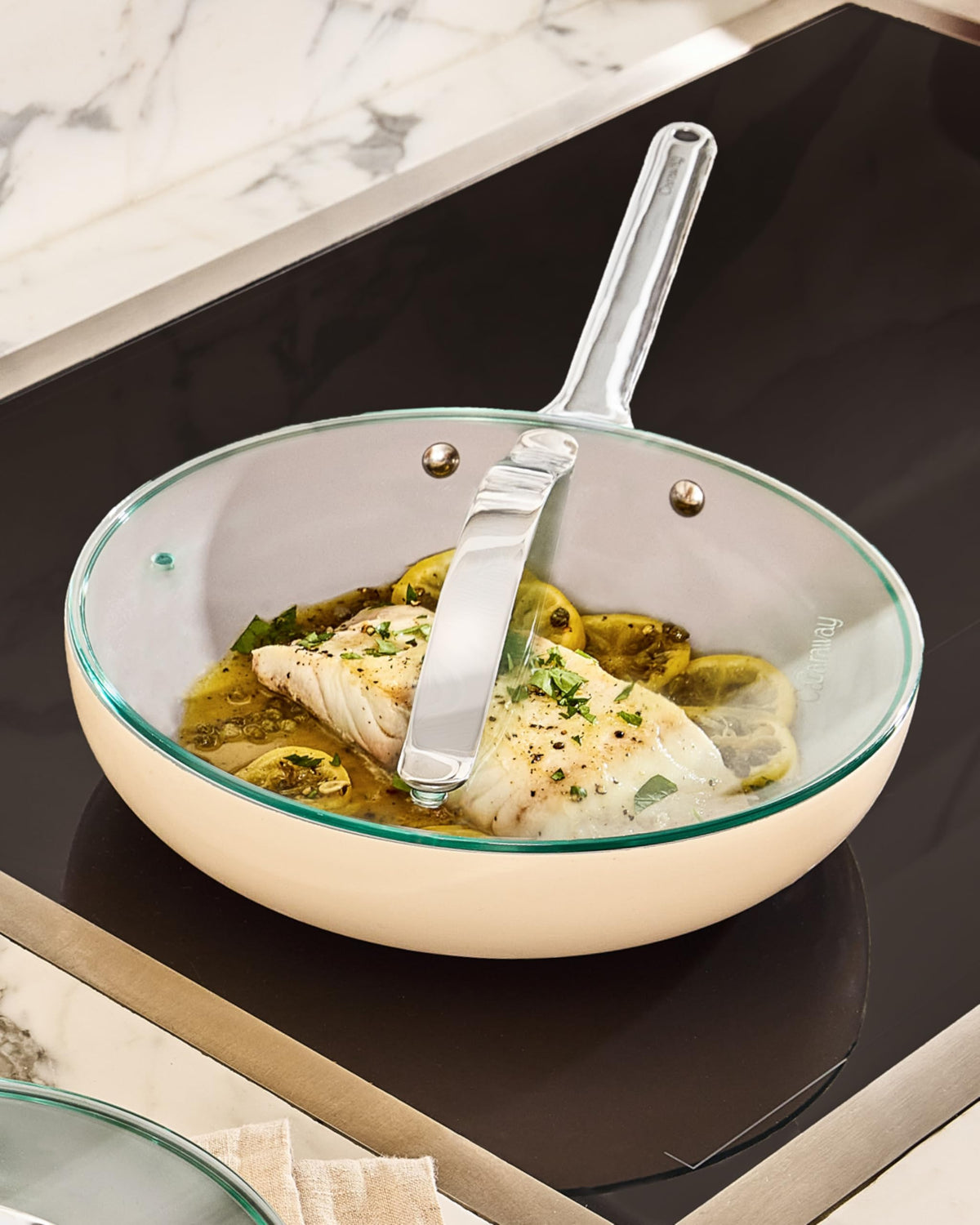 Caraway glass lid offers clear view while preserving heat during simmering