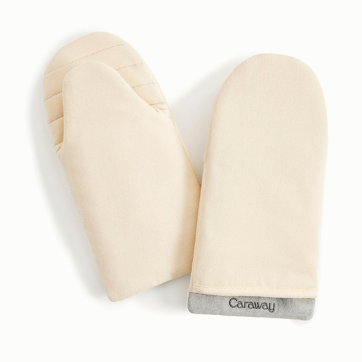 Caraway oven mitts in cream with a double-layer design for safer grip.