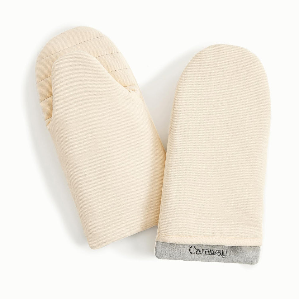 Caraway oven mitts in cream with a double-layer design for safer grip.