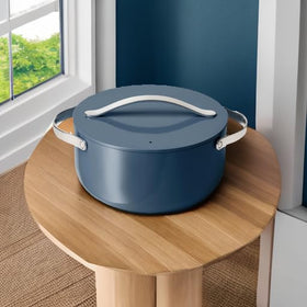 Caraway induction-compatible Dutch Oven on a modern stove for versatile cooking.