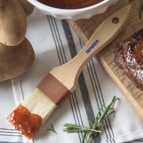 Angled head design supports natural grip for precise basting