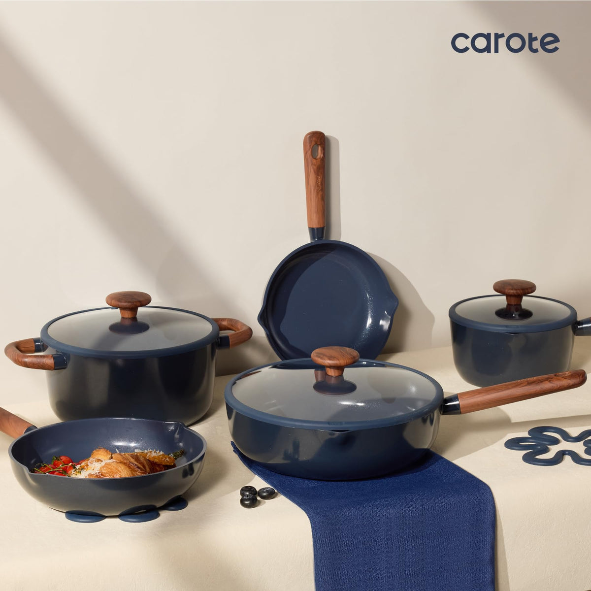 Pan protectors and silicone trivet with CAROTE set for storage.