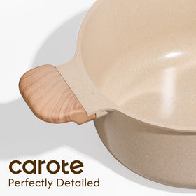 CAROTE stock pot on stove with steaming soup.