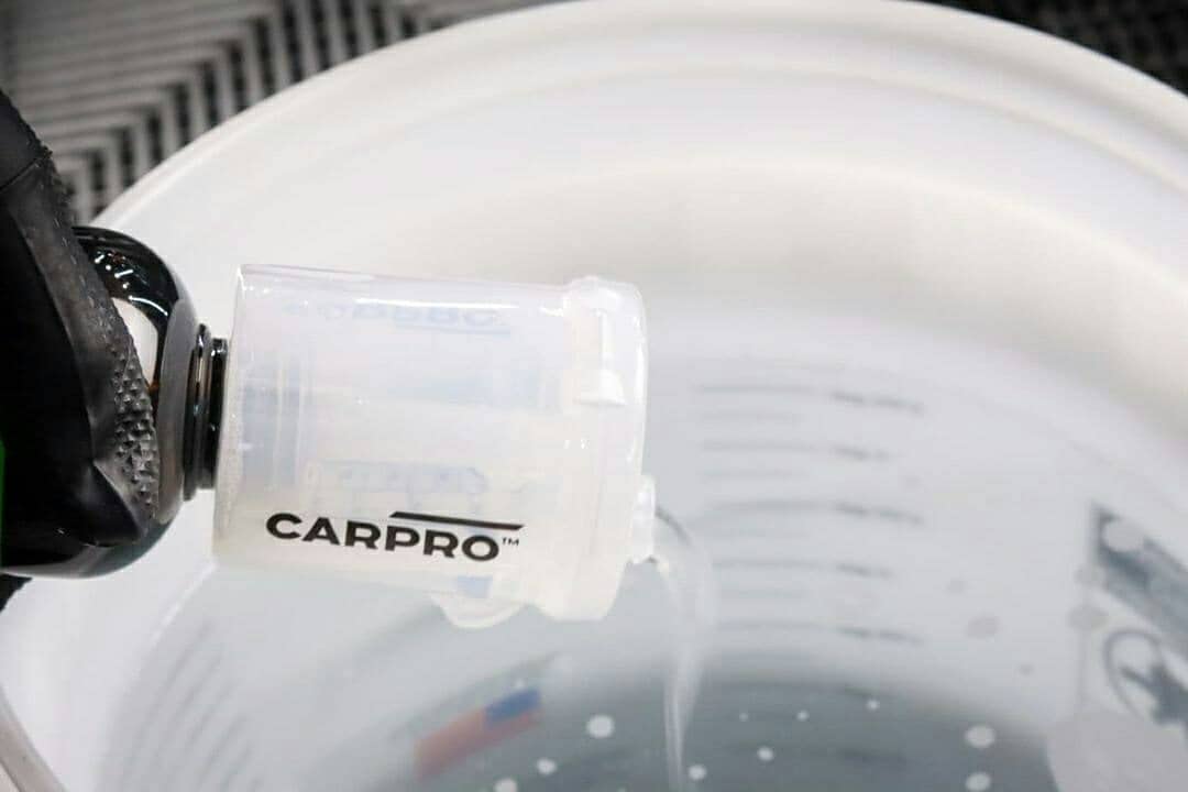 CARPRO Measure in car care setup for controlled mixing.