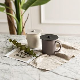 Carrotez heat-resistant lids cover a hot beverage safely.