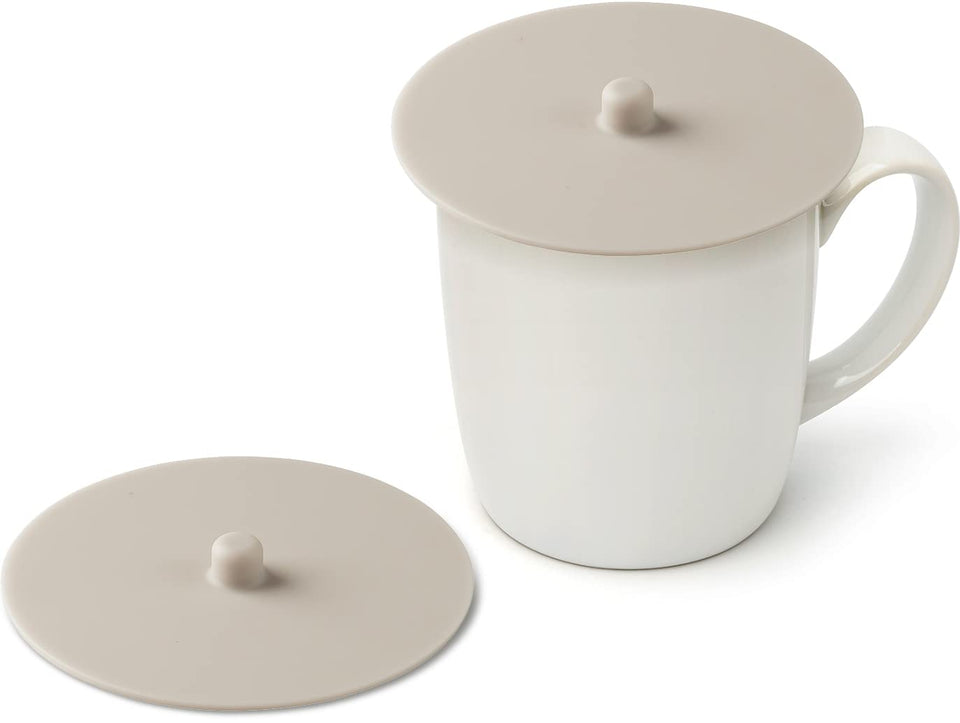 Carrotez ivory silicone cup covers in a 2-pack fit standard mugs for a dust-free seal.