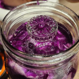 Cedilis flat-bottom design assists even submersion of vegetables in brine.