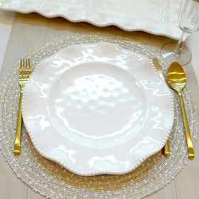 Perlette off-white melamine plates with beaded edge and scalloped design for versatile table settings.