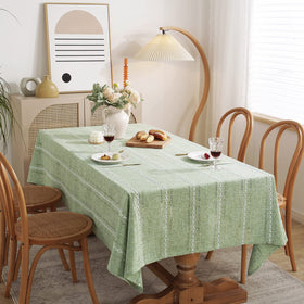 Chassic sage green tablecloth draped over a large rectangular table.