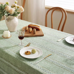 Chassic tablecloth ready for a dining setup with plates and glassware