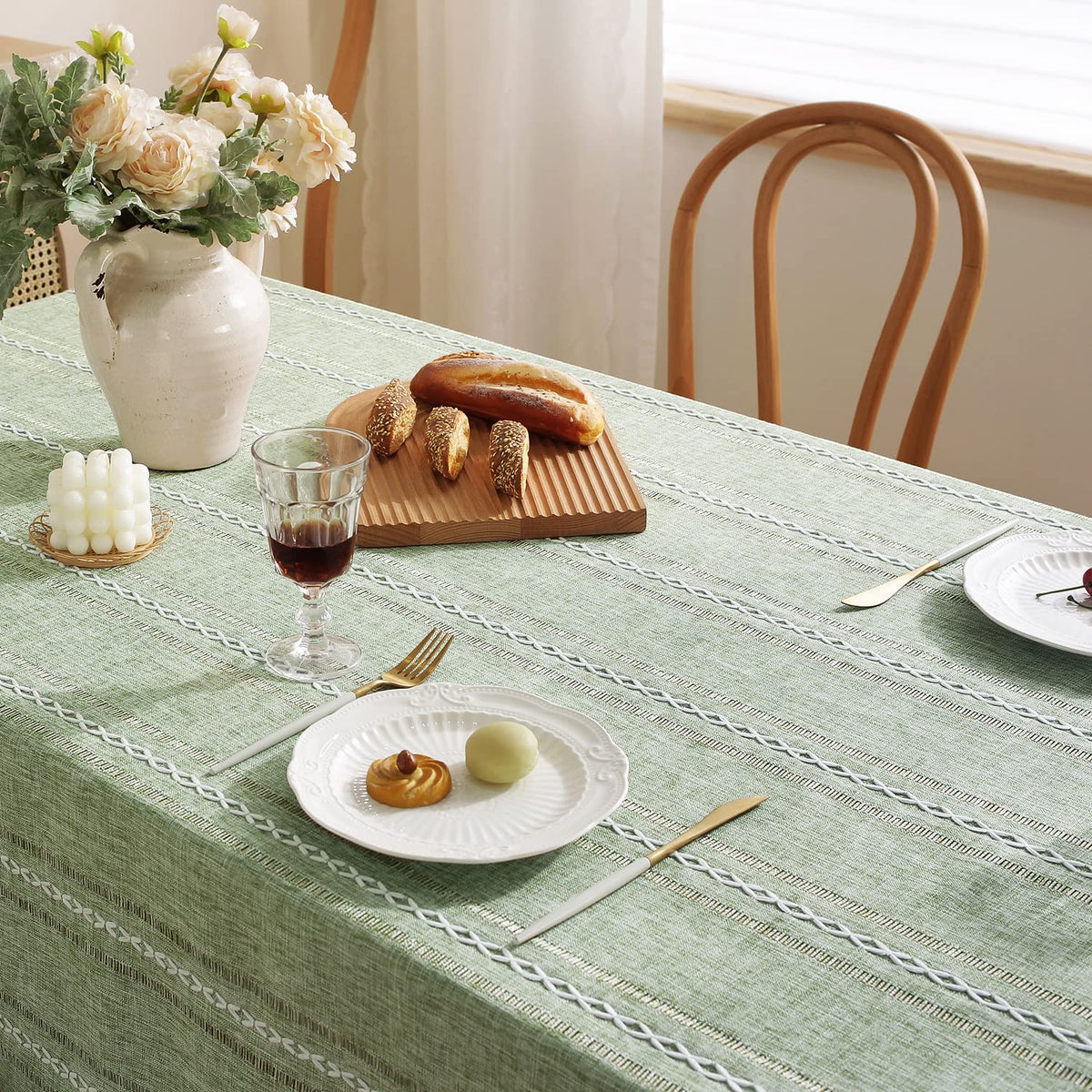 Chassic sage green dining ambience with tablecloth; calm, spring-ready mood.