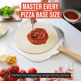 Chef Pomodoro peel in action lifting pizzas from hot oven.