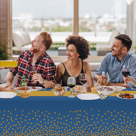 Childom party setup with blue-gold tablecloth enhances festive ambiance.