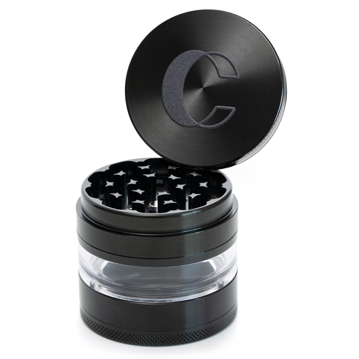 Cinder Brands Clear Cut grinder with transparent chamber showing herb texture during grinding