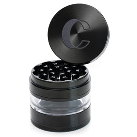 Cinder Brands Clear Cut grinder with transparent chamber showing herb texture during grinding