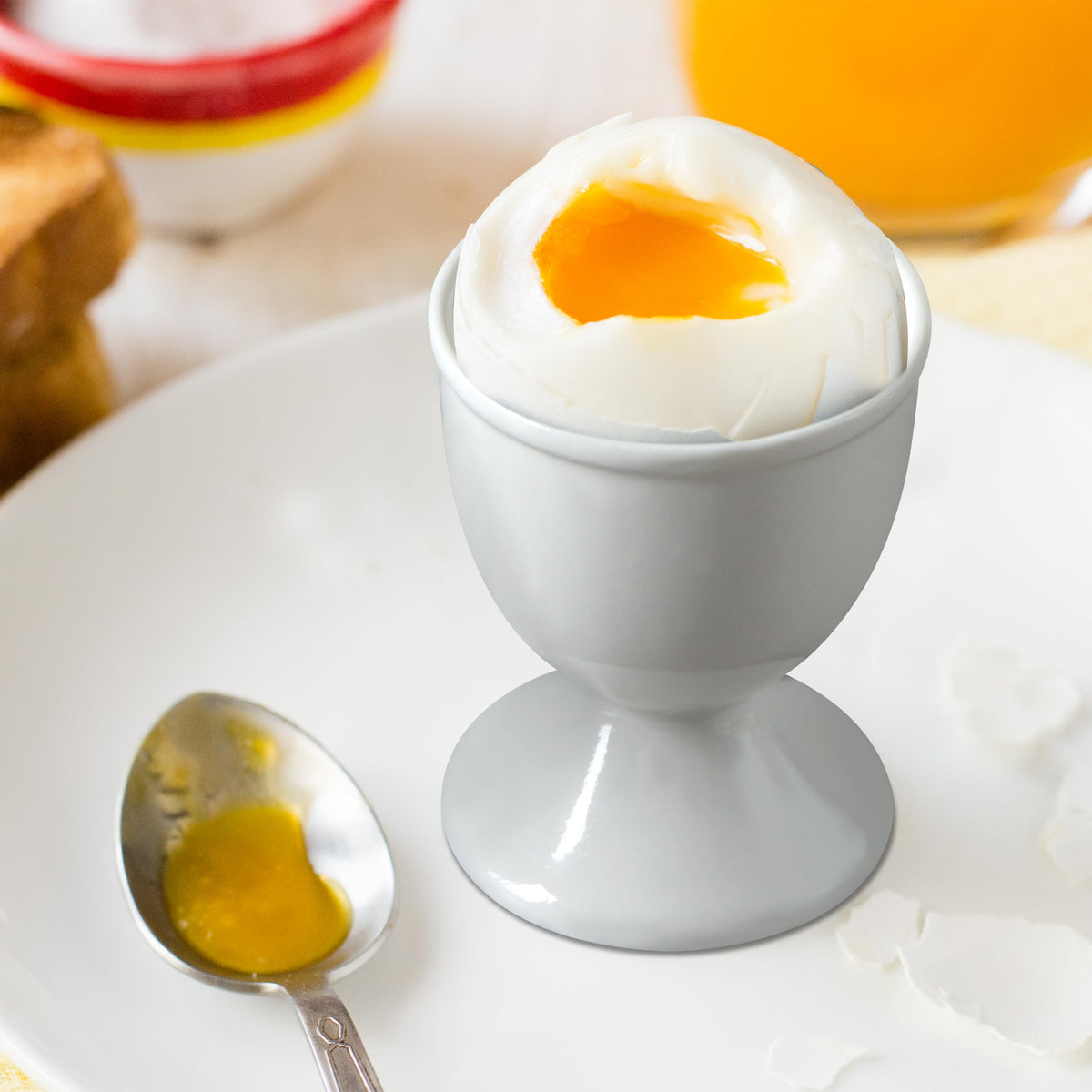 Cinf ceramic egg cups with flower pattern for elegant breakfast display.